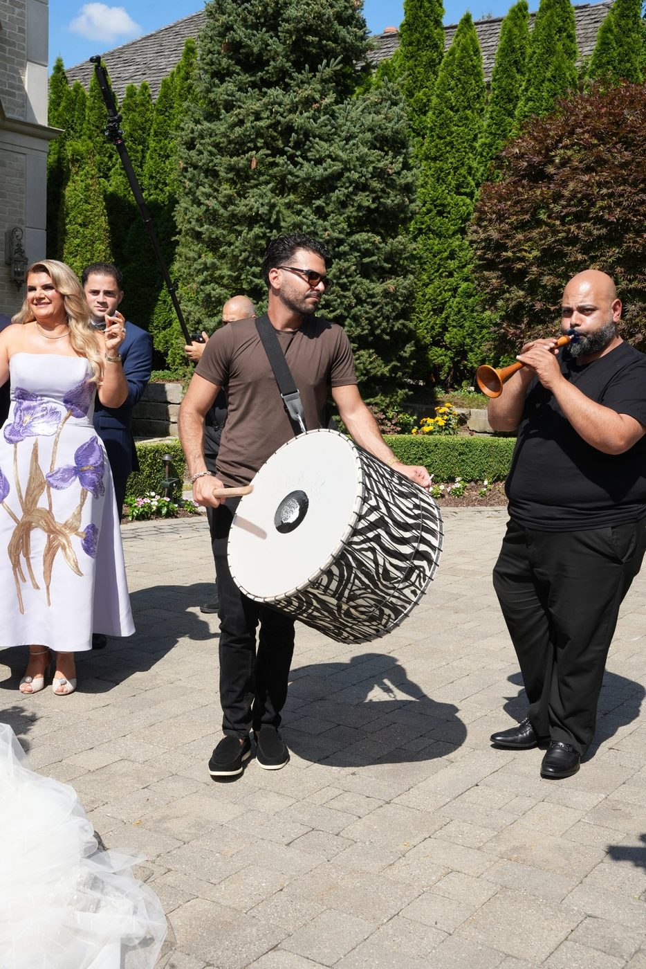 A tabl drummer and zorna player leading an outdoor daytime procession