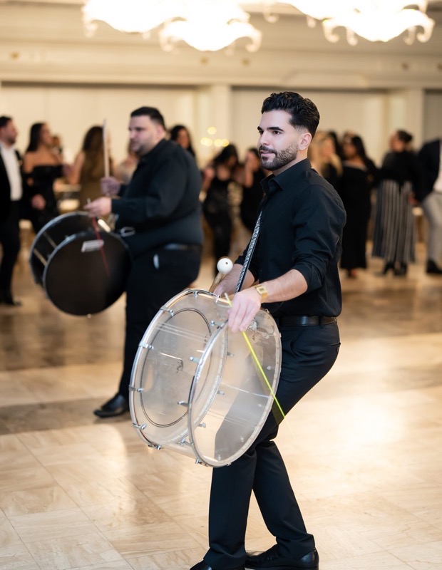 A Prestige Brothers drummer with a clear-shell snare on a ballroom floor